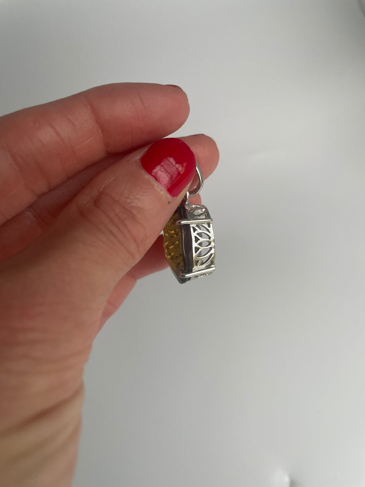 Side view of the smoky quartz pendant showing the openwork gallery