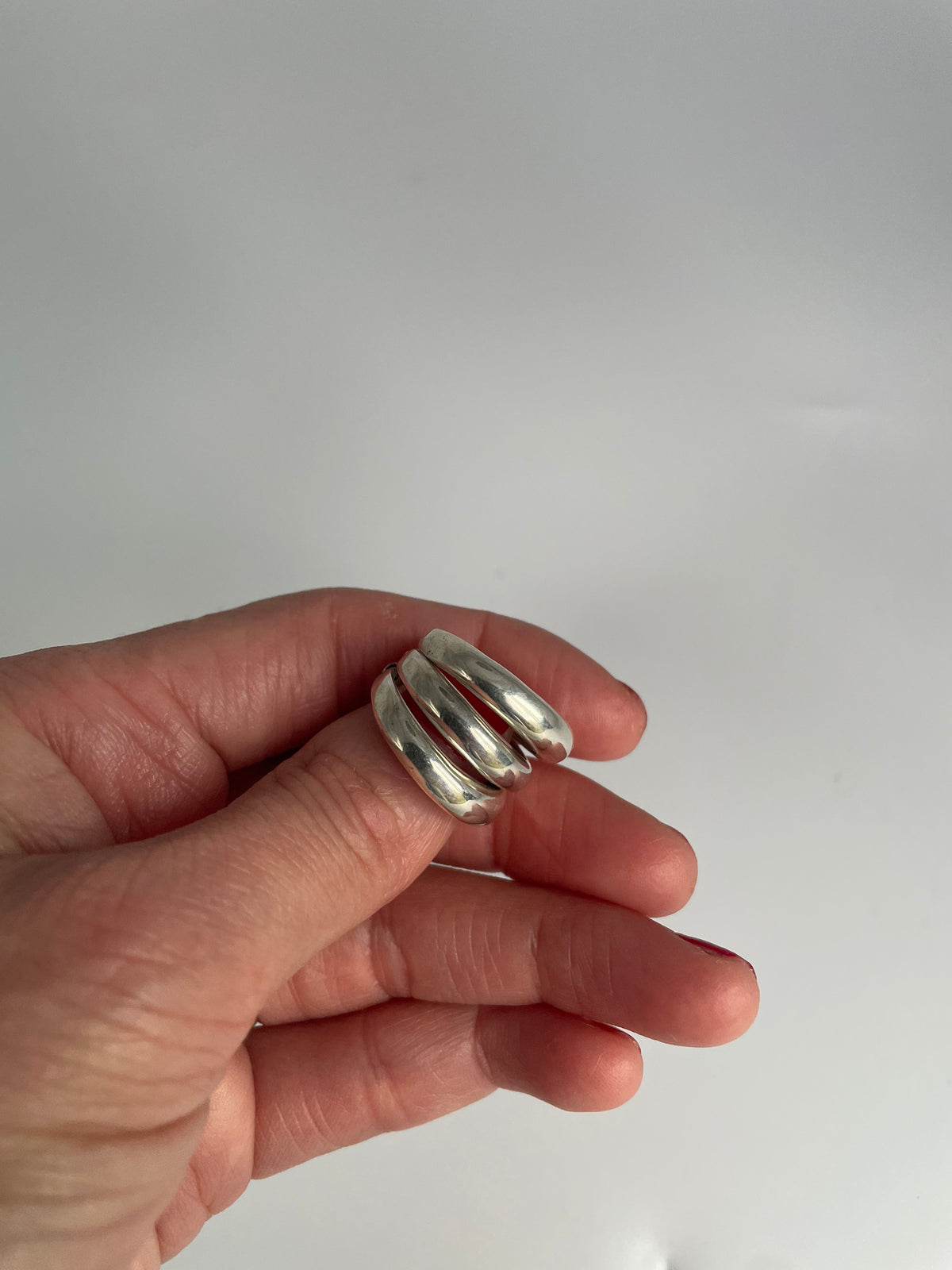 Three band stacked look silver ring, angled view