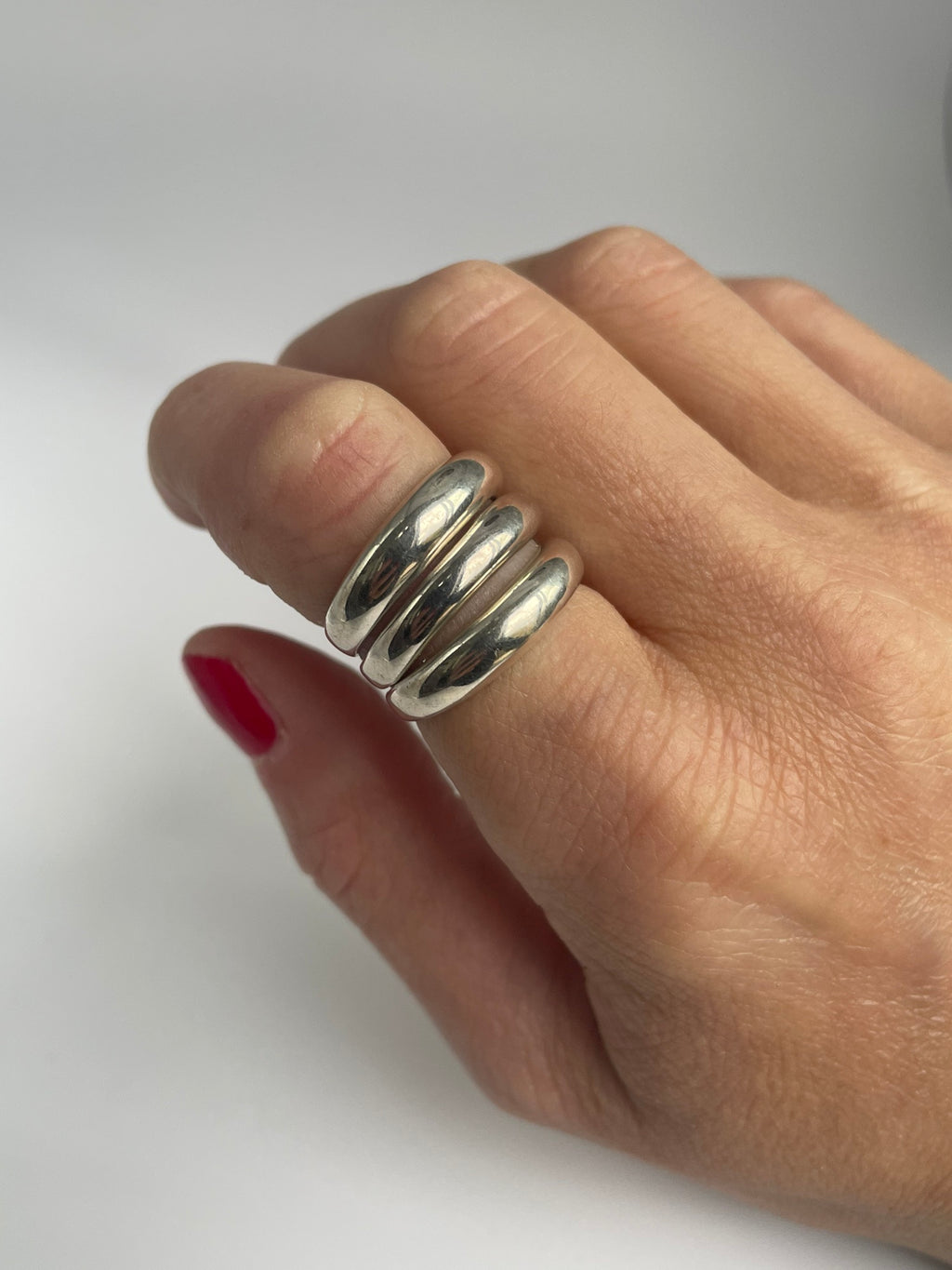 Triple band silver ring worn on the index finger