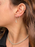 Crescent moon threader earring worn with the chain looped through a second piercing