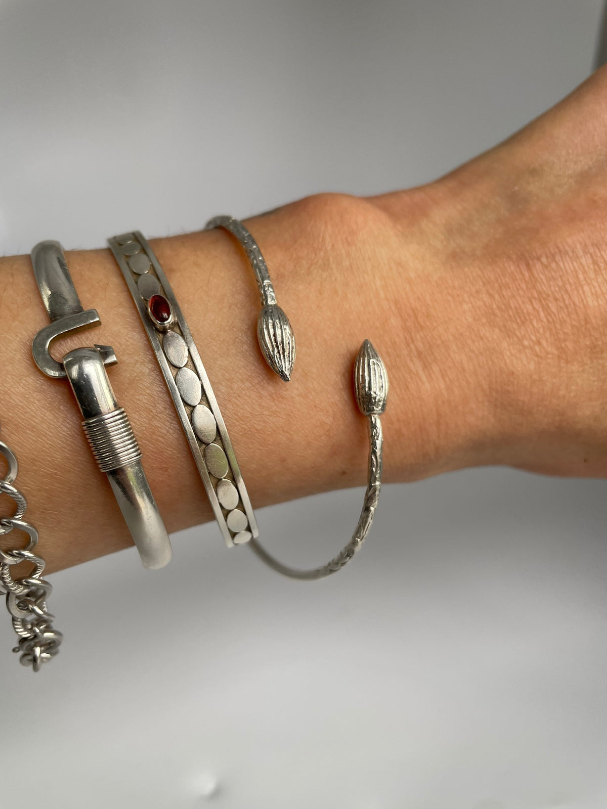 Cocoa pod cuff worn on the wrist, stacked with other bracelets for styling