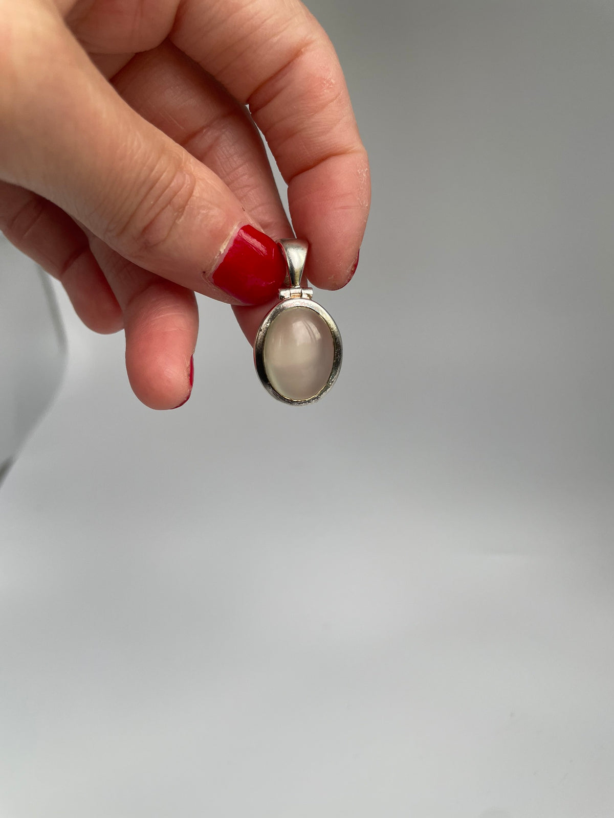 Cat's eye pendant hanging from its bail