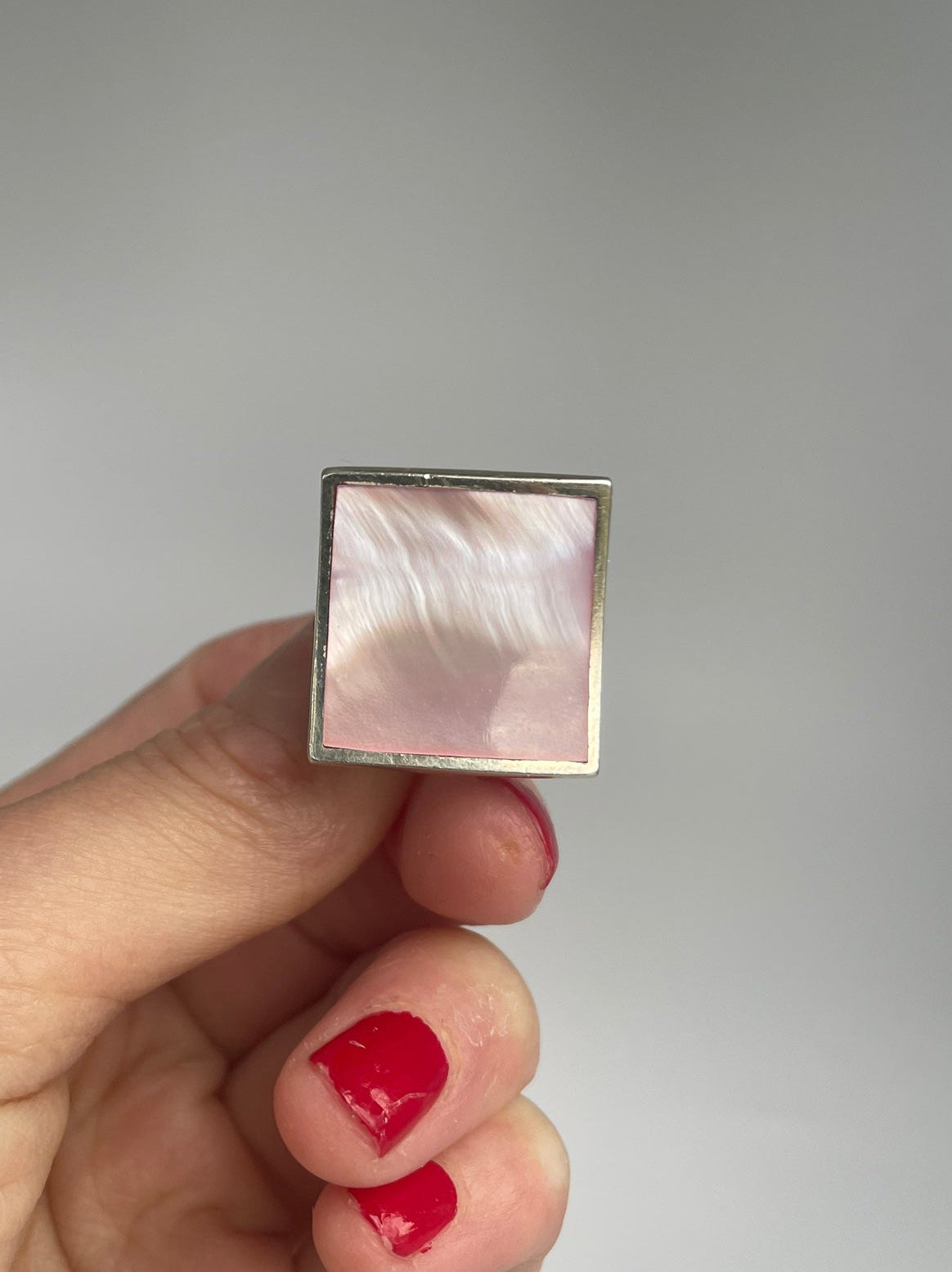 Close view of the square pink mother of pearl panel in a slim silver frame