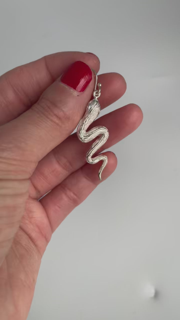 Video of the silver snake earring turning in the hand