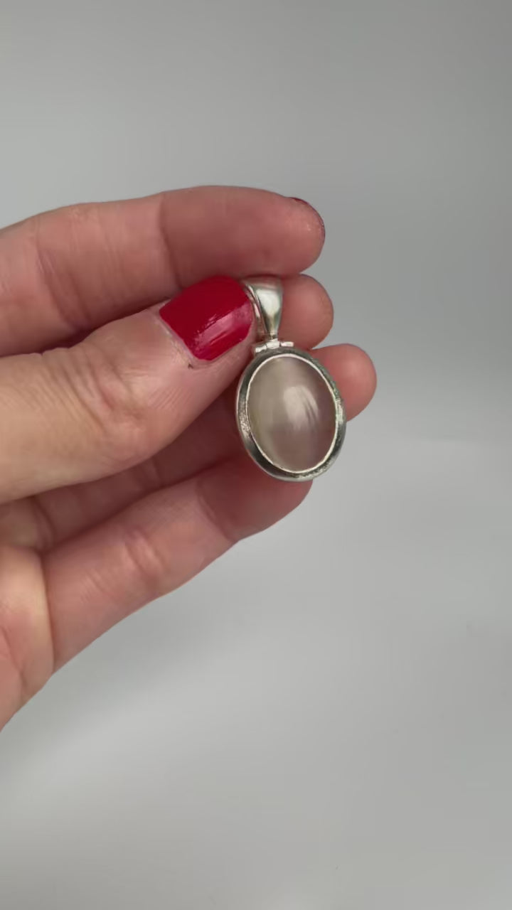 Video of the cat's eye pendant showing its sheen, front and back